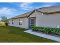 Rear view of house showing exterior features and landscaping at 13285 Crest Lake Dr, Hudson, FL 34669