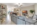 Open concept living area with a comfortable sofa and large TV at 13285 Crest Lake Dr, Hudson, FL 34669