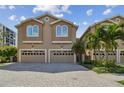 Two-story townhouse with a two-car garage and paver driveway at 348 Larboard Way, Clearwater, FL 33767