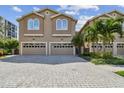 Two-story townhouse with a two-car garage and paver driveway at 348 Larboard Way, Clearwater, FL 33767