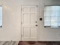Simple entry door with six panels and light-colored wood trim at 1318 Preston S St, St Petersburg, FL 33712