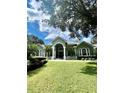 Elegant home with a grand entrance and manicured lawn at 168 Rue Des Chateaux, Tarpon Springs, FL 34688