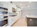 Modern kitchen with stainless steel appliances and white cabinets at 2251 Overfalls Pl, Wesley Chapel, FL 33543