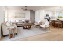 Open living room features hardwood floors, stylish furniture, and a view into the kitchen at 0 Trapper John Rd, Weeki Wachee, FL 34614