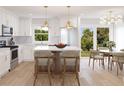 Modern kitchen with white cabinets, marble countertops, and an island with seating at 0 Trapper John Rd, Weeki Wachee, FL 34614