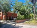 Two-story coral home with lush landscaping and driveway at 817 S West Shore Blvd, Tampa, FL 33609