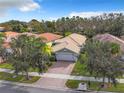 Attractive single-Gathering home with a two-car garage and landscaped yard at 15810 Cobble Mill Dr, Wimauma, FL 33598