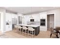 Modern kitchen with white cabinets, island, and stainless steel appliances at 0 Dusky Warbler Rd, Weeki Wachee, FL 34614