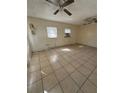 Large living room with tile floors and ceiling fan at 411 S Orleans Ave, Tampa, FL 33606