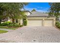 Two-story house with three-car garage and nicely landscaped front yard at 3320 Majestic View Dr, Lutz, FL 33558