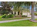 Well-maintained house with a three-car garage and lush landscaping at 3320 Majestic View Dr, Lutz, FL 33558