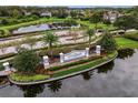 Stonebriar community entrance with a lake and lush landscaping at 3320 Majestic View Dr, Lutz, FL 33558