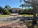 House exterior showcasing landscaping and brick driveway at 11919 Royce Waterford Cir, Tampa, FL 33626