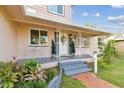 Inviting front porch with a charming sitting area and landscaping at 2709 17Th S St, St Petersburg, FL 33712