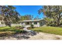 Newly renovated home with a modern facade and landscaped front yard at 12020 82Nd E St, Parrish, FL 34219