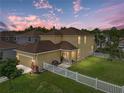 Aerial view of home, fenced backyard, and garage at 8720 Savory Walk Dr, Land O Lakes, FL 34637