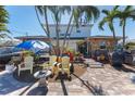 Brick paved front yard with tropical landscaping at 14180 W Parsley Dr, Madeira Beach, FL 33708
