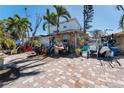 Brick paved front yard with tropical landscaping at 14180 W Parsley Dr, Madeira Beach, FL 33708