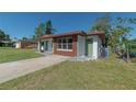 Newly renovated home with a modern exterior, featuring a green door and brown accents at 1328 Barry St, Clearwater, FL 33756