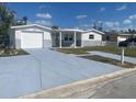 This beautiful home features a garage and a covered front porch, perfect for enjoying the outdoors at 4803 Guardian Ave, Holiday, FL 34690
