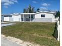 Single-story home with a well-maintained lawn and a white picket fence, offering classic curb appeal at 4803 Guardian Ave, Holiday, FL 34690