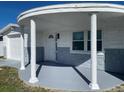 Welcoming front porch featuring decorative support columns, great for relaxing and enjoying the neighborhood views at 4803 Guardian Ave, Holiday, FL 34690