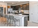 Well-equipped kitchen featuring an island with seating, stainless steel appliances, and ample cabinet space at 6674 Michael Favor Way, Wesley Chapel, FL 33545