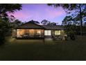 Screened porch and backyard at dusk at 8991 Long Lake Ave, Weeki Wachee, FL 34613