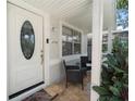 Inviting front porch with seating and tiled flooring at 6908 N Oregon Ave, Tampa, FL 33604