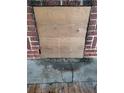 Brick fireplace with a wooden cover and damaged hearth at 1868 Mississippi Ne Ave, St Petersburg, FL 33703