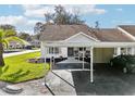 Single-story villa with carport and well-maintained lawn at 7631 Bloomingdale Dr, New Port Richey, FL 34654