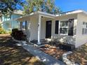 Inviting front entrance with updated landscaping and a welcoming walkway at 3033 W Helen Ave, Tampa, FL 33611