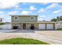 Charming two-story home featuring a covered porch, two-car garage, and well-manicured lawn at 7886 9Th S Ave, St Petersburg, FL 33707