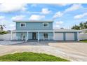 Charming two-story home featuring a covered porch, two-car garage, and well-manicured lawn at 7886 9Th S Ave, St Petersburg, FL 33707