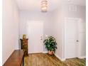 Bright entryway featuring wood-look floors, fresh paint and decorative lighting at 802 Highgate Oaks Pl, Seffner, FL 33584