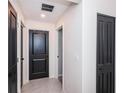 Clean hallway with tile flooring and neutral walls at 14906 Imperial Purple Ln, Wimauma, FL 33598