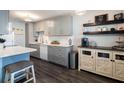 Modern kitchen with grey cabinets and white appliances at 650 Pinellas Point S Dr # 211, St Petersburg, FL 33705