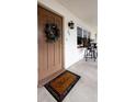 Inviting front door with a welcome mat and porch seating at 650 Pinellas Point S Dr # 211, St Petersburg, FL 33705
