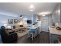 Open concept living and kitchen with grey cabinets at 650 Pinellas Point S Dr # 211, St Petersburg, FL 33705