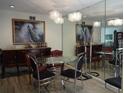 Dining room with glass table, dark wood hutch and chandelier at 13936 Clubhouse Cir # 13936, Tampa, FL 33618
