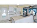White kitchen with island, built-in microwave, and breakfast nook at 176 Philadelphia Lot 5 Blvd, Palm Harbor, FL 34684