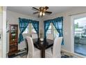 Cozy dining area with dark wood table and teal curtains at 176 Philadelphia Lot 5 Blvd, Palm Harbor, FL 34684