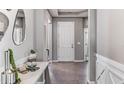 Bright and airy foyer with contemporary decor and tiled floors at 10741 Tippecanoe Pl, Parrish, FL 34219