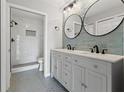 Modern bathroom with double vanity, hex floor tile, and walk-in shower at 1662 Seascape Cir # 205, Tarpon Springs, FL 34689