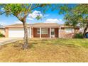 Front view of a ranch-style home with a covered porch and attached garage at 5621 Moog Rd, New Port Richey, FL 34652