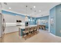 Modern kitchen with island, stainless steel appliances, and blue accents at 707 Winterside Dr, Apollo Beach, FL 33572