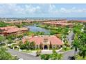 Resort-style community clubhouse with swimming pool and lush landscaping at 2717 Via Cipriani # 622B, Clearwater, FL 33764