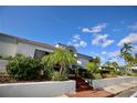 Condo community building with lush landscaping at 1901 Oyster Catcher Ln # 814, Clearwater, FL 33762