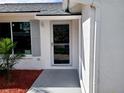 Inviting front entrance with a glass door and gray shutters at 3233 Lenwood Dr, New Port Richey, FL 34655