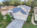 Exterior view of single-story home with attached garage and landscaping at 5544 Legend Hills Ln, Spring Hill, FL 34609